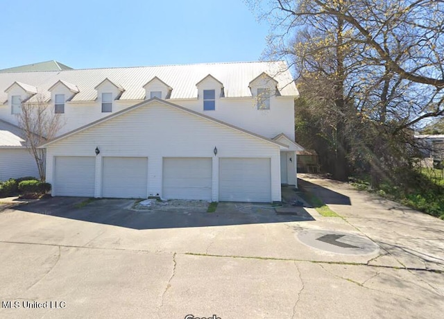 new england style home featuring a garage