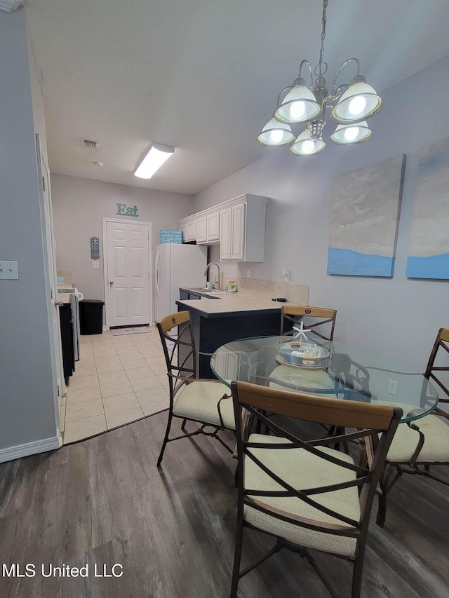 dining room featuring sink and light hardwood / wood-style floors