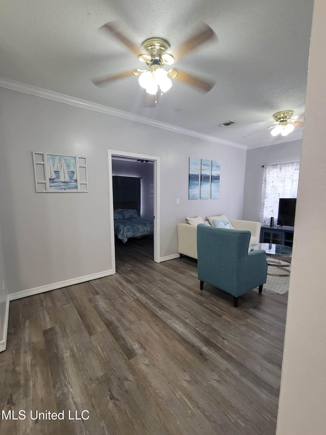 living room featuring crown molding, dark hardwood / wood-style flooring, ceiling fan, and a textured ceiling