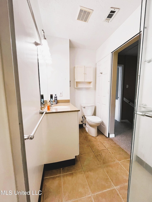 2501 Gulf Ave Unit 22, Gulfport, MS 39501 - bathroom featuring vanity, toilet, and tile patterned flooring