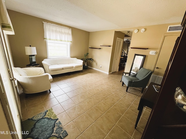 2501 Gulf Ave Unit 22, Gulfport, MS 39501 - tiled living room featuring healthy amount of natural light, a textured ceiling, and baseboards
