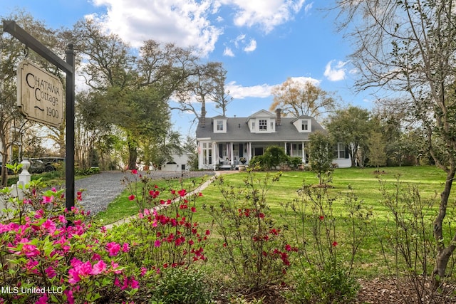 cape cod house with a porch and a front yard