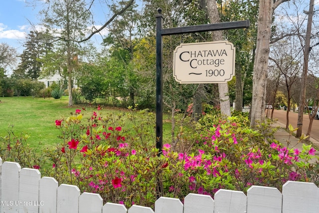 community / neighborhood sign with a lawn