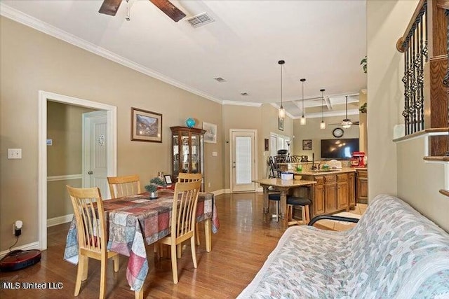 19101 Rucks Krans Rd, Moss Point, MS 39562 - dining space featuring wood finished floors, crown molding, baseboards, and a ceiling fan