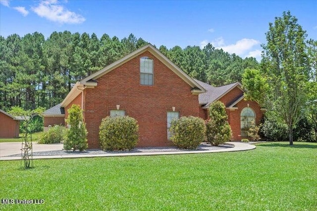 19101 Rucks Krans Rd, Moss Point, MS 39562 - view of property exterior featuring a lawn, brick siding, and concrete driveway