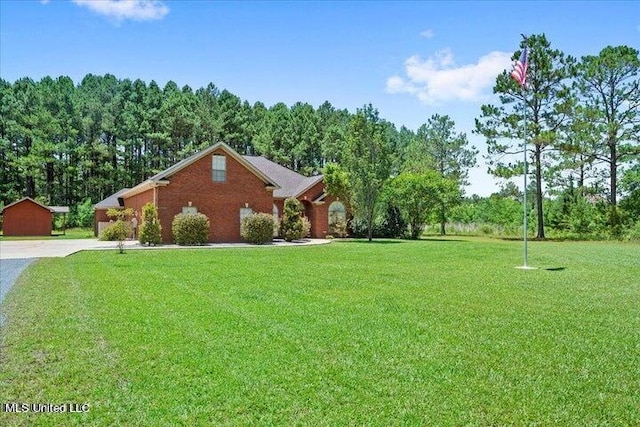 19101 Rucks Krans Rd, Moss Point, MS 39562 - view of home's exterior with driveway, a yard, and brick siding