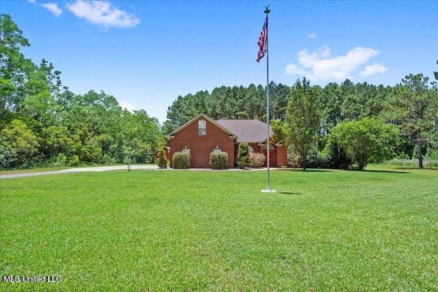 19101 Rucks Krans Rd, Moss Point, MS 39562 - view of front of property with a front lawn, driveway, a forest view, and a garage