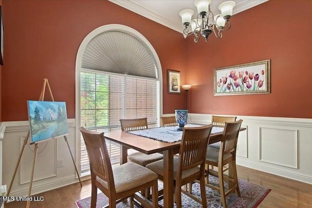 19101 Rucks Krans Rd, Moss Point, MS 39562 - dining area with a chandelier, a wainscoted wall, a decorative wall, wood finished floors, and crown molding