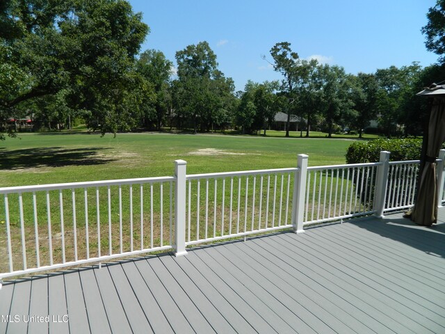 wooden deck featuring a yard