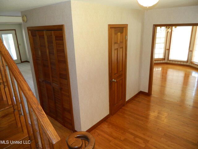 corridor with light hardwood / wood-style flooring