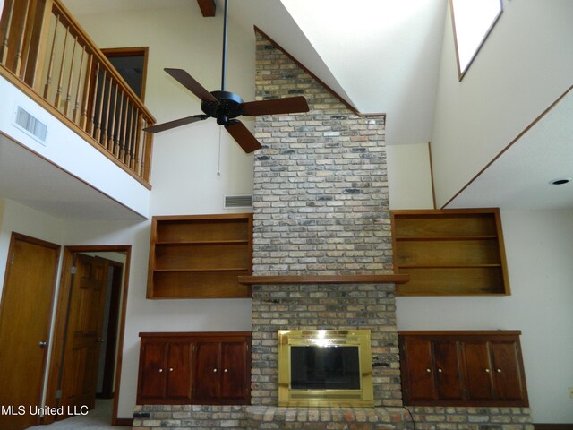 unfurnished living room featuring high vaulted ceiling and ceiling fan