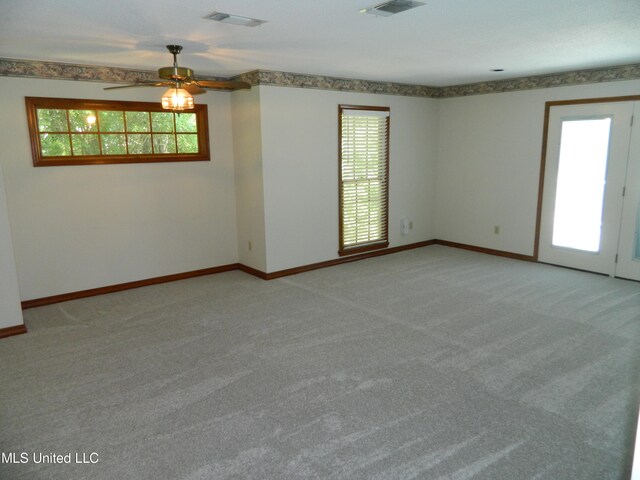 spare room featuring light carpet and ceiling fan