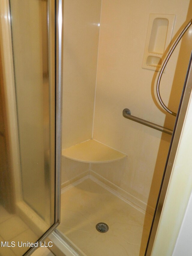 bathroom featuring a shower with door