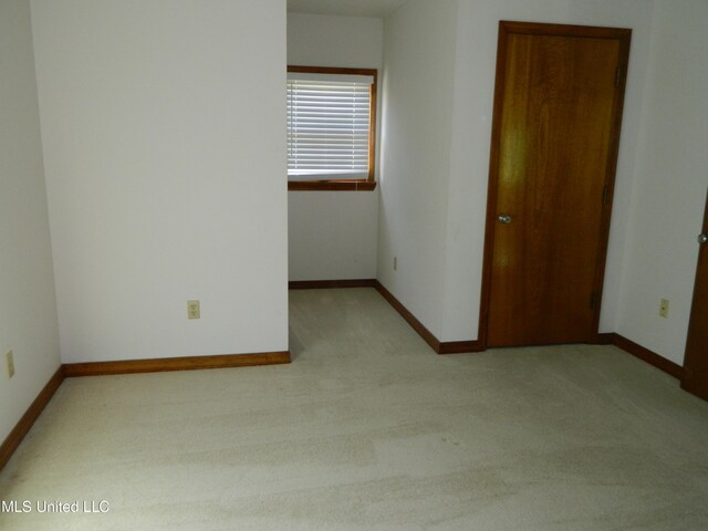 spare room with light carpet