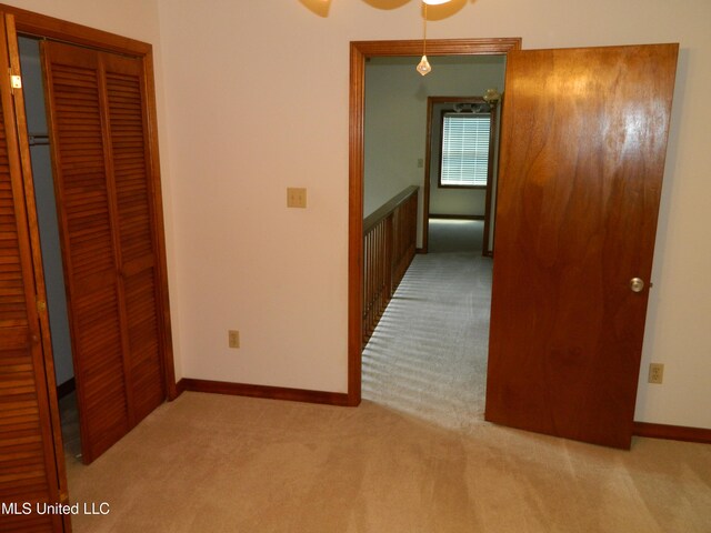 hallway with light colored carpet