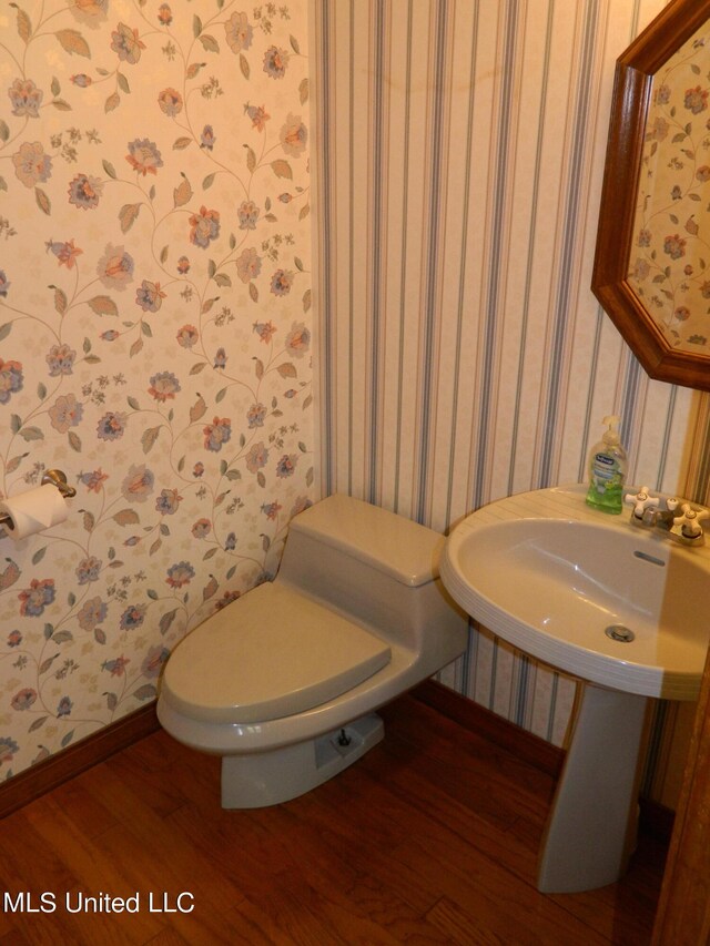 bathroom featuring toilet and hardwood / wood-style flooring