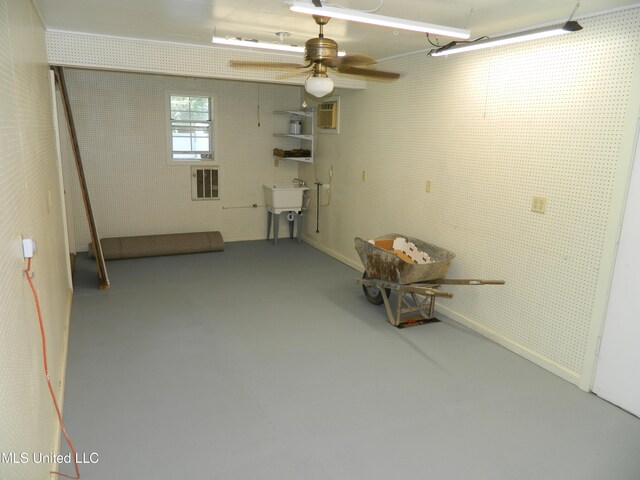 basement featuring sink and ceiling fan