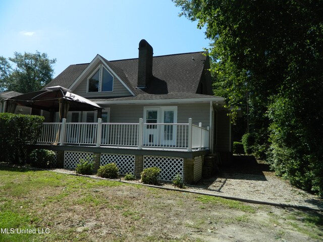 rear view of house with a wooden deck