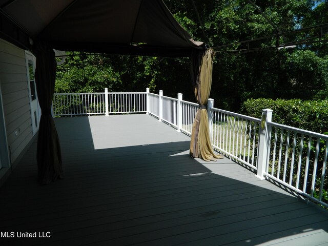 wooden terrace featuring a gazebo