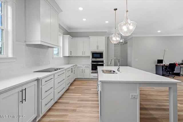 kitchen featuring white cabinetry, a healthy amount of sunlight, stainless steel oven, and sink