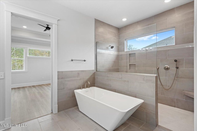 bathroom with shower with separate bathtub, wood-type flooring, and plenty of natural light