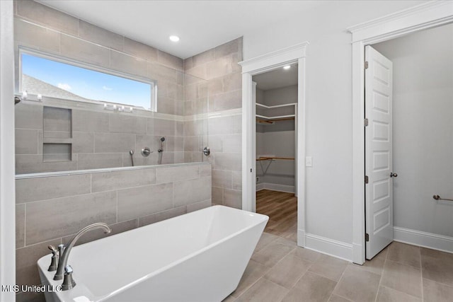 bathroom featuring a tub to relax in and tile patterned flooring