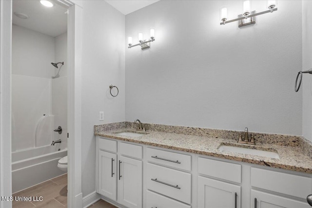 full bathroom featuring toilet, shower / washtub combination, hardwood / wood-style floors, and vanity