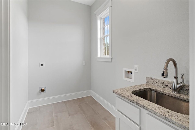 washroom featuring hookup for a washing machine, electric dryer hookup, cabinets, and sink