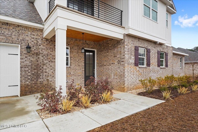 doorway to property featuring a balcony and a garage