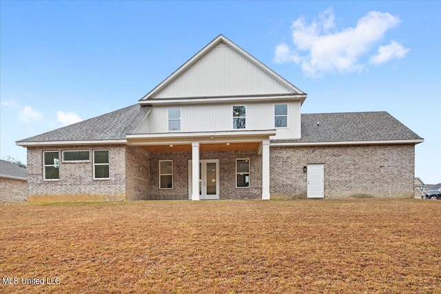 rear view of property featuring a yard