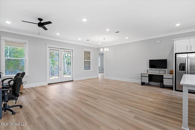 living room featuring ornamental molding, ceiling fan with notable chandelier, and light wood-type flooring