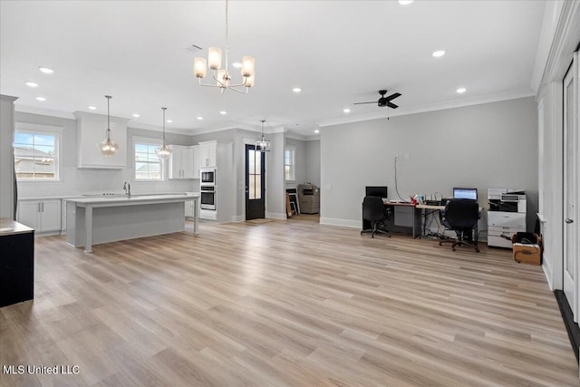 office space with crown molding, light wood-type flooring, and ceiling fan