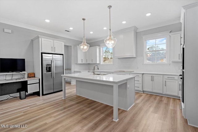 kitchen featuring light hardwood / wood-style flooring, a kitchen island with sink, stainless steel fridge with ice dispenser, and white cabinets