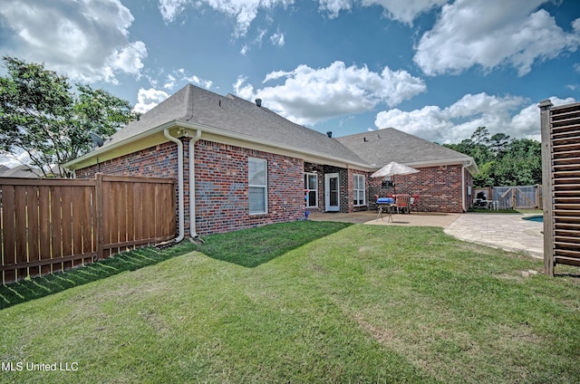312 Faith Way, Brandon, MS 39042 - back of property featuring brick siding, a patio, and roof with shingles
