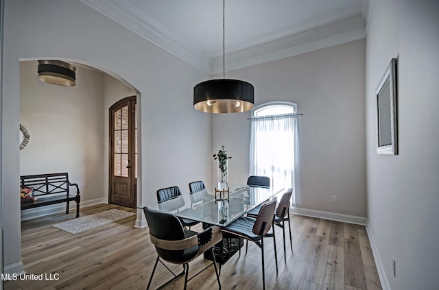 312 Faith Way, Brandon, MS 39042 - dining space with light wood-style floors, arched walkways, baseboards, and ornamental molding