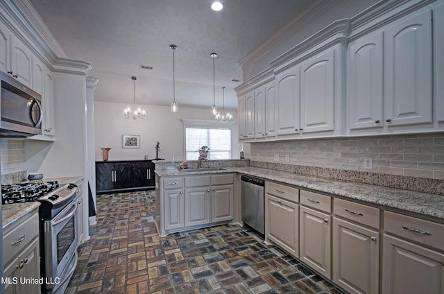 312 Faith Way, Brandon, MS 39042 - kitchen with stainless steel appliances, a chandelier, a sink, brick patterned flooring, and tasteful backsplash