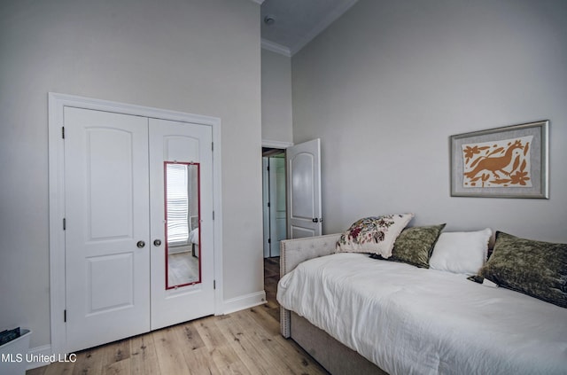 312 Faith Way, Brandon, MS 39042 - bedroom featuring a towering ceiling, light wood finished floors, ornamental molding, baseboards, and a closet