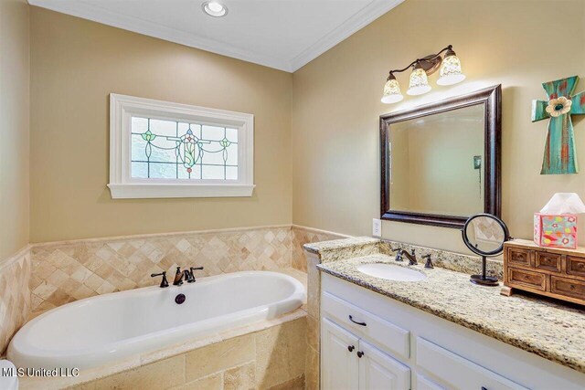 full bathroom with ornamental molding, a bath, and vanity