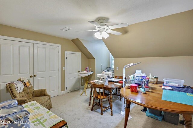 dining space featuring light carpet, a ceiling fan, and lofted ceiling