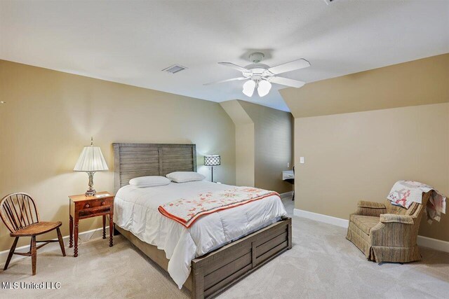 bedroom featuring visible vents, baseboards, ceiling fan, and light colored carpet