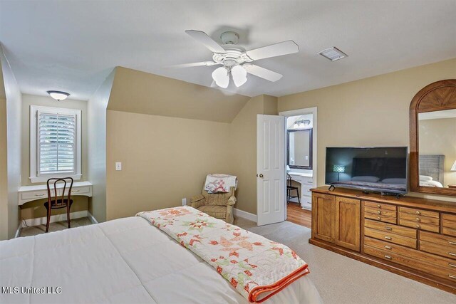 bedroom featuring light carpet, a ceiling fan, baseboards, lofted ceiling, and visible vents