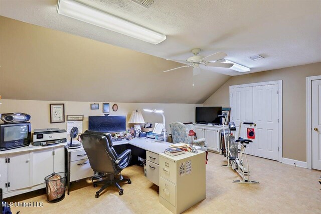 office area featuring a textured ceiling, ceiling fan, vaulted ceiling, and visible vents