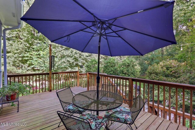 wooden terrace with outdoor dining area