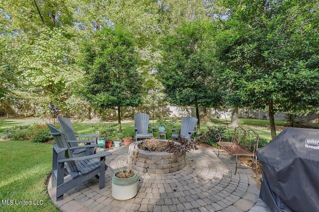 view of patio / terrace with a fire pit and grilling area