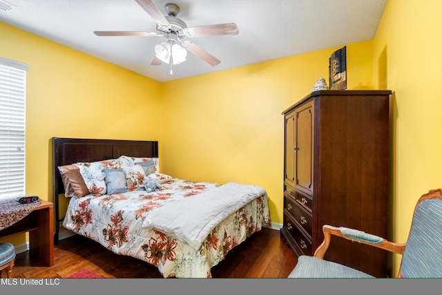 bedroom with dark wood-type flooring and ceiling fan