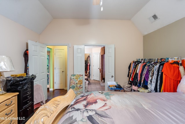 tiled bedroom featuring lofted ceiling