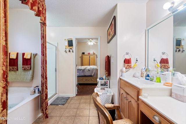 bathroom with tile patterned flooring, ceiling fan, a textured ceiling, independent shower and bath, and vanity