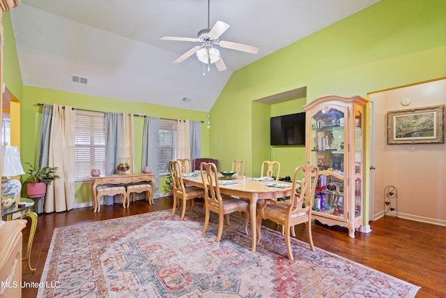 dining space featuring lofted ceiling, dark wood-type flooring, and ceiling fan