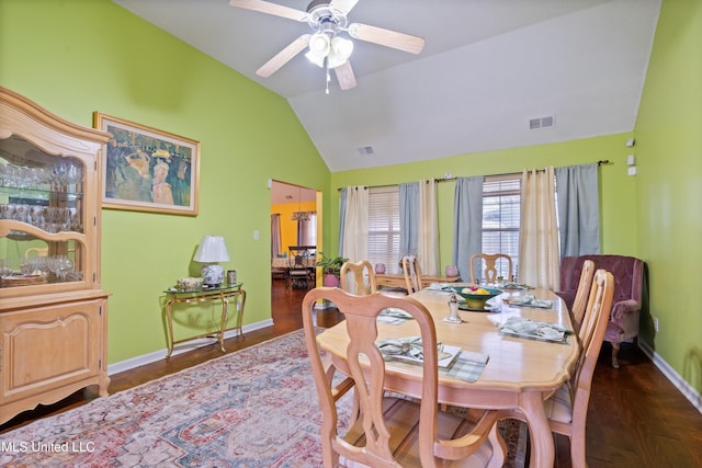 dining area featuring dark wood-type flooring, ceiling fan, and lofted ceiling