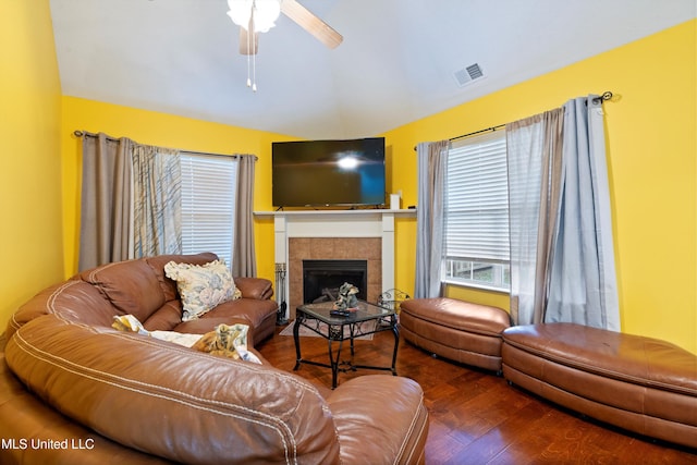 living room featuring a fireplace, wood-type flooring, and ceiling fan